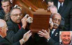 Honour for a friend ... Olympic athletes Tommie Smith, left, and John Carlos carrying the coffin of Peter Norman (inset) from Williamstown Town Hall yesterday.